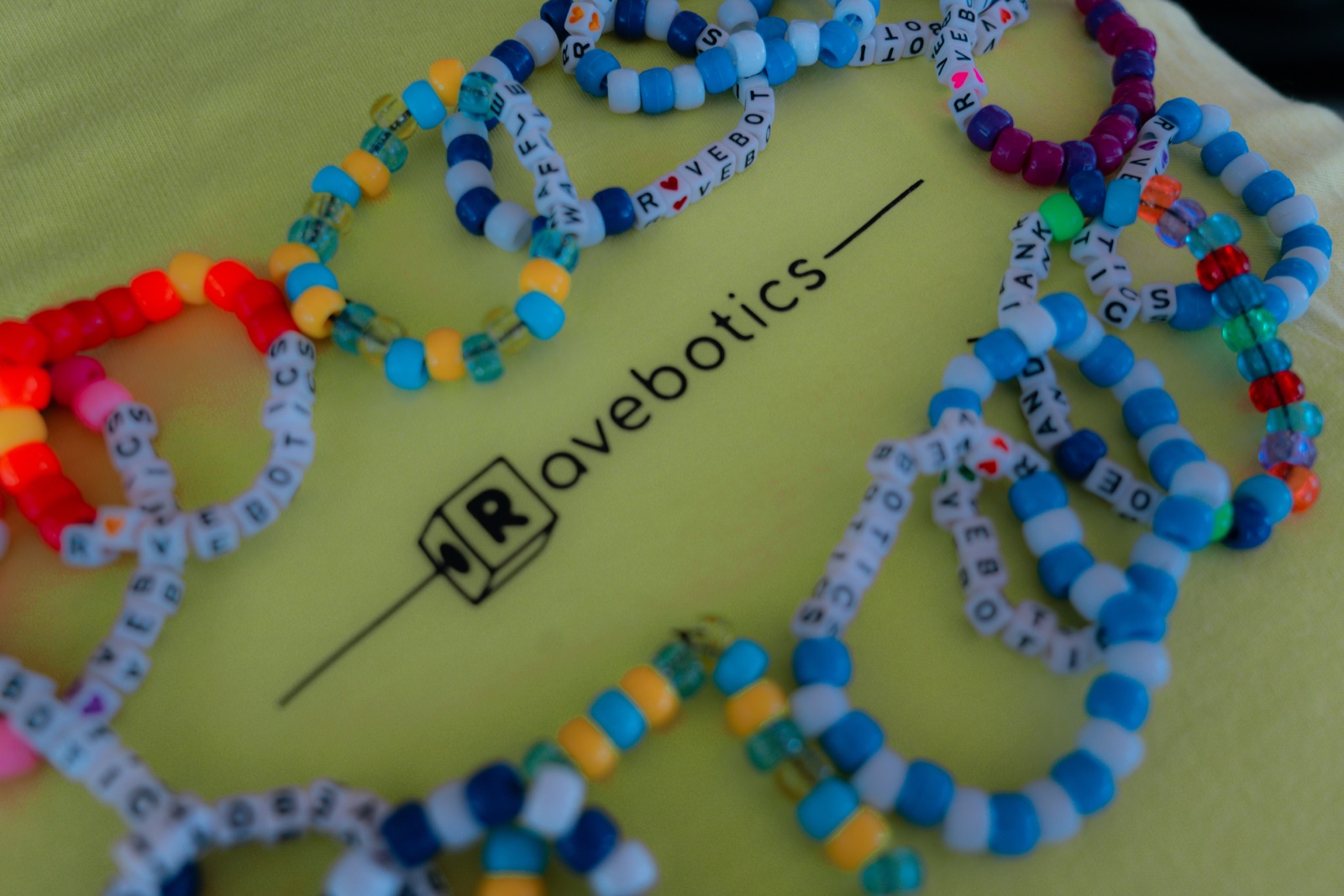 custom RAVEBOTICS bracelets on a Ravebotics shirt